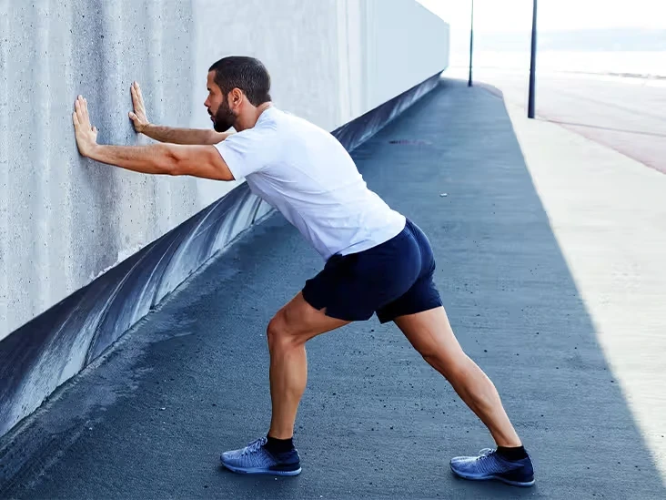 Image of a man stretching his calf