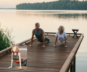 An image of an older couple doing gentle yoga stretches by the water during a morning exercise routine for energy.