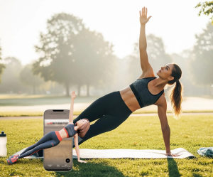 A photo of a woman performing a side plank outdoors during a morning workout to boost energy.