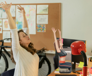 An image of a woman raising her arms in an overhead stretch to improve posture after long hours of sitting.