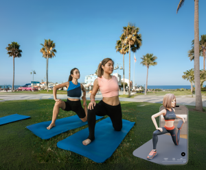 An image of two women performing lunging stretches on yoga mats for a daily full-body stretch routine.