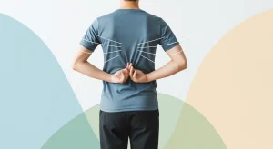 A photo of a person standing with hands clasped behind their back, with gentle lines around the shoulder blades to show chest opening.