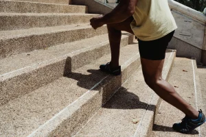 A photo of a runner walking up steps during a warm-up exercise before a run.