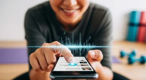 An image of a person smiling while tapping a playlist on their phone, with illustrated sound waves and music notes rising from the screen, suggesting how music enhances workouts.